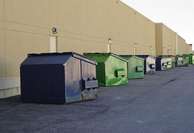 a truck unloading construction waste into a dumpster in Bemidji